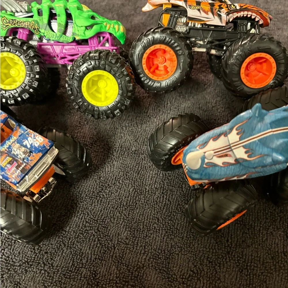 Hot Wheels 4 lot of Monster Truck Toys. Assorted Colors (Green, Orange, Blue)